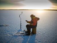 A man is ice-fishing at midday on the frozen Bothnia Sea, on December 28, 2016 in Vaasa, Western Finland. (OLIVIER MORIN/ AFP)