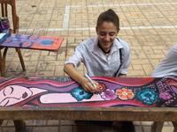 Girls painting school chairs in Giza. (Maha Zein/ Facebook)