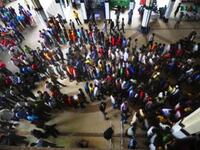 Bangladesh: Bangladeshi travellers queue to collect tickets at a railway station in Dhaka, ahead of the Muslim festival of Eid Al-Fitr. City workers make their way home for the holiday.