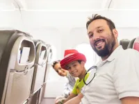 Arab man and kids plane seats looking up