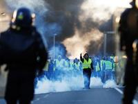People stand as a man gestures in front of gendarmes on Caen's circular road on November 18, 2018 in Caen, northwestern France.
CREDITCHARLY TRIBALLEAU / AFP
