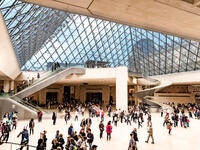 People at the main entrance of Louvre museum, under the famous glass Pyramid. (Shutterstock/ File)