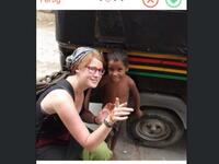 aid worker posing with foreign child
