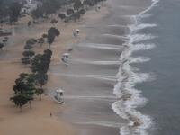 A man jogs along Repulse Bay beach after the hoisting of signal number 9 warning as super Typhoon Mangkhut starts to slam Hong Kong on September 16, 2018. 
Mark RALSTON / AFP