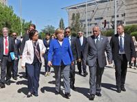 German Chancellor Angela Merkel walks during her Jordan visit in the German-Jordanian University in the Jordan city of Madaba, June 21, 2018. (AFP Ahmad Abdo)