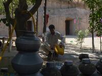 Pakistani villager Ameer Ullah Khan washes his hands outside his cave home in Nikko village.
AAMIR QURESHI / AFP
