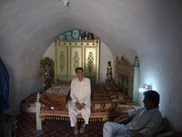 Pakistani villager Ameer Ullah Khan (L) chats with a friend in his cave room in Nikko village.
AAMIR QURESHI / AFP