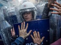 A Turkish female riot police officer reacts during clashes with women's rights activists as they try to march to Taksim Square to protest against gender violence in Istanbul, on November 25, 2018, on the International Day for the Elimination of Violence against Women. 
BULENT KILIC / AFP
