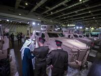 Egyptian military officers talk with Saudi men at the Saudi stand during Egypt’s first Service Defence Exhibition in Cairo on December 3, 2018, at the International Exhibition Center. 
Khaled DESOUKI / AFP
