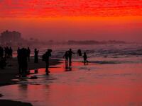 Palestinian people walk on the beach at sunset west of in Gaza city on December 31, 2018. 
MAHMUD HAMS / AFP


