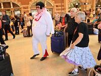 Elvis fans dance to Elvis songs at Central station before boarding a train to to The Parkes Elvis Festival, in Sydney on January 10, 2019. 
PETER PARKS / AFP