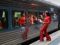 An Elvis fan uses the train window as a mirror at Central station before boarding a train to The Parkes Elvis Festival, in Sydney on January 10, 2019. 
PETER PARKS / AFP