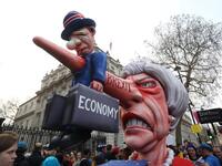 A puppet head of Britain's Prime Minister Theresa May spearing a representation of the British economy is positioned on Whitehall outside Downing Street after a march and rally organised by the pro-European People's Vote campaign for a second EU referendum in central London on March 23, 2019. 
Isabel INFANTES / AFP