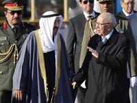 Tunisian President Beji Caid Essebsi (R) welcomes Kuwait's Emir Sheikh Sabah al-Ahmad al-Sabah upon his arrival at Tunis-Carthage international airport on March 30, 2019, to attend the Arab Summit. 
Hussein Malla / POOL / AFP