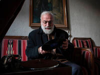 Mohammed Anis puts a record on his trusty gramophone at his home in Aleppo. His family gone, his home bombed out, the record player is one of the few things still working - and a main source of joy for him. 