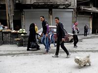 Life going back to normal. A Syrian man walks his dog in the previously rebel-held al-Shaar neighborhood in the northern city of Aleppo on March 10, 2017. 
