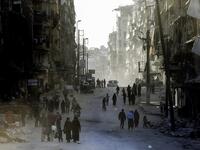 Syrians walk the streets of the formerly rebel-held neighborhood of al-Shaar in Aleppo, which was recaptured by government forces in December 2016. 