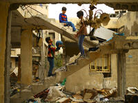 Playing in and with the ruins of war can be dangerous. Many children fall victim to unexploded ordnance rockets. Here Palestinian children play in a building destroyed during the 50-day war between Israel and Hamas militants in the summer of 2014 in Gaza City.