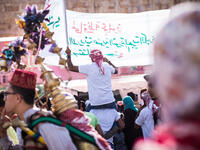 A parade chanting slogans in support of King Abdullah II passes through the crowd outside King Hussein Park in Amman, Jordan, as people gathered to celebrate the 100th anniversary of the Great Arab Revolt on June 3, 2016.