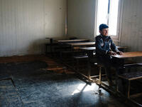 An Iraqi boy sits at a desk in a school in eastern Mosul. In January 2017, schools have started to re-open for the first time in three years. Under the control of Daesh, schools were either closed or followed the extremists’ group curricular. As a result, many children have been missing out on education during that time.