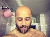 bald man in shower
