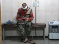 A Syrian man waits to receive treatment at a make-shift hospital in Kafr Batna following government air strikes on the town of Jisreen, in the besieged Eastern Ghouta region on Feb. 19, 2018. 
(Ammar SULEIMAN / AFP)