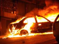 A vehicle burns following a car bomb attack outside the Al-Qiddissine (The Saints) church.