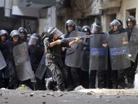 Egyptian riot police clash with stone-throwing Christian youths  outside the Al-Qiddissine church.