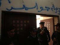 Palestinian security forces stand guard at the entrance of the Al-Jazeera offices in the West Bank city of Ramallah after some protesters stormed into the building and sprayed Arabic graffiti equating the pan-Arab news channel's staff to (Israeli) "spies".