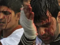 Ashura's rituals: Shia men & women dressed in black parade the streets slapping their chests & 
chanting. Things can get ugly, even violent, with all the raised testosterone around (even if mostly directed at oneself).
Still, today, blood-spilling or self-injury is frowned upon and has been toned down, or kept to the minimum symbolic gestures.
