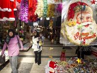 Arab-Israeli women walk past stalls selling Christmas decorations at a market in the Arab-Israeli town of Nazareth.