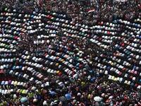 Mass mid-protest prayer session in the iconic Tahrir Square (AFP)