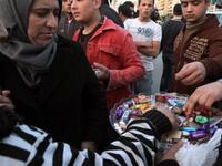 In Lebanon, sweets are distributed outside the embassy in Beirut to celebrate the sweet victory marked by the resignation of Egypt's Hosni Mubarak, President of the Republic of Egypt, Friday, February 11, 2011.