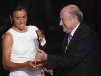Marta (L) of Brazil winner of the women's player of the year receives her award from FIFA President Sepp Blatter (R).