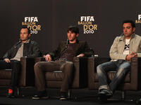 Lionel Messi (C) of Argentina alongside Xavi (R) and Andres Iniesta (L) of Spain during a press conference ahead of the FIFA Ballon d'or Gala.