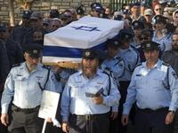 Israeli police officers carry the coffin of their comrade, Haifa Police Chief Ahuva Tomer, who died of her wounds after she was trapped with her car in raging fires which erupted in the Carmel Forest near Haifa.m