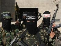 Armed Palestinians are seen following a press conference.