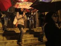 Lebanese women perform a dance in a street as rain approaches the mediterranean country after several months of drought.