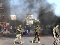 The Lebanese army are seen on the streets as supporters of the Future Movement burn tires in a neighborhood in the capital Beirut during a demonstration in support of the caretaker prime minister Saad Hariri.