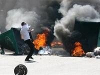 Garbage skips are set on fire.