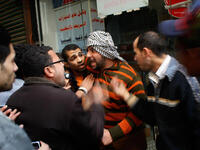 Egyptians regroup and argue about strategy in a side alley during a clash between pro- and anti-Mubarak protesters.