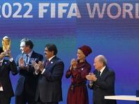 Sheikh Mohammed bin Hamad al-Thani, chairman of the Qatar 2022 bid committee, (L) raises the World Cup trophy as he stands with Qatar's Emir Sheikh Hamad bin Khalifa al-Thani (C), his wife Sheikha Moza and FIFA president Joseph Blatter (R).