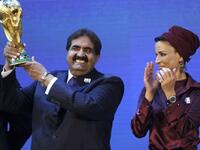 Emir of the State of Qatar Sheikh Hamad bin Khalifa Al-Thani (L) poses by his wife Sheikha Moza bint Nasser Al-Missned with the World Cup trophy after the official announcement that Qatar will host the 2022 World Cup.