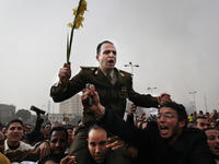 Protesters carry an army captain on their shoulders after he tore up a poster of Egyptian President Hosni Mubarak.