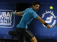 Novak Djokovic of Serbia returns the ball to Tunisian Malek Jaziri during their ATP tennis match on the third round of the Dubai Duty Free Tennis Championships on February 24, 2016. World number one Novak Djokovic recorded his 700th career win when he cruised past Jaziri and into the Dubai Tennis Championships quarter-finals.
KARIM SAHIB / AFP