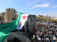 Syrian protesters wave the flag of the opposition as they demonstrate against the regime and its ally Russia, in the rebel-held city of Idlib on September 7, 2018. (OMAR HAJ KADOUR / AFP)
