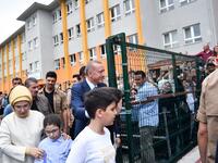 Turkey's President Recep Tayyip Erdogan, leader of the Justice and Development Party (AKP), his wife Emine and their grandchildren are greeted by supporters as they leave the polling station after casting their votes during snap twin Turkish presidential and parliamentary elections in Istanbul on June 24, 2018. (Bulent Kilic / AFP)