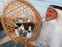 Emiratis train their children on handicraft industries during the Dalma Sailing Festival. (KARIM SAHIB / AFP)