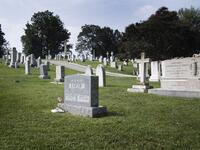 A flag is placed at the base of the tombstone of US Navy admiral Charles "Chuck" Larson at the US Naval Academy in Annapolis, Maryland, on August 24, 2018, near where US Senator John McCain will be laid to rest next. (AFP)
