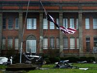 An American flag is torn in front of a school during Hurricane Michael October 10, 2018 in Panama City, Florida. (Brendan Smialowski / AFP)